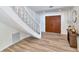 Bright foyer featuring hardwood floors, elegant staircase, and stylish decor at 451 Palm Ne Is, Clearwater Beach, FL 33767