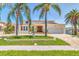 Charming single-Gathering home showcasing a manicured front yard, brick driveway, and traditional architecture at 451 Palm Ne Is, Clearwater Beach, FL 33767