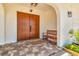 Inviting front porch with a double door entry, wooden bench, and tiled flooring at 451 Palm Ne Is, Clearwater Beach, FL 33767