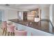 Modern kitchen featuring a bar countertop with stools, stainless steel appliances, and white cabinetry at 451 Palm Ne Is, Clearwater Beach, FL 33767