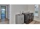 Laundry room with sink, modern washer and dryer, and waterfront view at 451 Palm Ne Is, Clearwater Beach, FL 33767