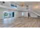Spacious living room boasts high ceilings, modern light fixture, and sliding glass doors to outdoor pool at 451 Palm Ne Is, Clearwater Beach, FL 33767