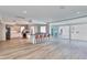 Spacious open-concept living area with wood flooring, kitchen island, and sliding glass doors at 451 Palm Ne Is, Clearwater Beach, FL 33767