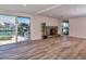 Living room featuring a stone fireplace, waterfront view, and wood flooring at 451 Palm Ne Is, Clearwater Beach, FL 33767