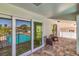 Outdoor patio featuring tiled floor, comfortable seating, and a view of the inviting pool and waterfront at 451 Palm Ne Is, Clearwater Beach, FL 33767