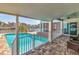 Covered patio with tiled floors, providing a view of the pool and waterfront at 451 Palm Ne Is, Clearwater Beach, FL 33767