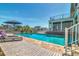 Backyard pool area, featuring wood deck, lounge chairs, and a view of the pool and waterfront at 451 Palm Ne Is, Clearwater Beach, FL 33767