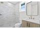 Bathroom featuring modern fixtures, walk-in shower with white subway tile, and glass shelving at 468 44Th N Ave, St Petersburg, FL 33703