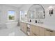 Bright bathroom featuring double vanity, modern fixtures, a soaking tub, and natural light at 468 44Th N Ave, St Petersburg, FL 33703