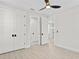 Bright bedroom features double closets, white trim, light wood floors, and a ceiling fan, creating a welcoming atmosphere at 468 44Th N Ave, St Petersburg, FL 33703