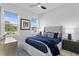 Bright bedroom with a plush bed, blue accents, natural light from two windows, and a modern ceiling fan at 468 44Th N Ave, St Petersburg, FL 33703
