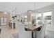 Bright dining area with modern chandelier, table, and a view into the open kitchen layout at 468 44Th N Ave, St Petersburg, FL 33703