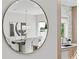 View through a decorative mirror showing an elegant dining room with modern chandelier and artwork at 468 44Th N Ave, St Petersburg, FL 33703