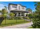 Two-story home with manicured lawn, black fence, and mature landscaping at 468 44Th N Ave, St Petersburg, FL 33703