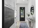 Bright and airy entryway features stylish decor, a modern door, and eye-catching artwork at 468 44Th N Ave, St Petersburg, FL 33703