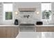 Close-up of modern kitchen featuring sleek stainless steel appliances and stylish lighting against a marble backsplash at 468 44Th N Ave, St Petersburg, FL 33703