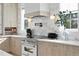 Gourmet kitchen with stainless steel appliances, a stylish backsplash, and custom cabinetry at 468 44Th N Ave, St Petersburg, FL 33703