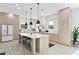 Bright and modern kitchen with a large island, stainless steel appliances, and stylish pendant lighting at 468 44Th N Ave, St Petersburg, FL 33703