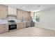 This spacious kitchen features stainless steel appliances, bright cabinets, and light hardwood flooring at 468 44Th N Ave, St Petersburg, FL 33703