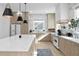 Well-appointed kitchen with a large island, quartz countertops, and stainless steel appliances at 468 44Th N Ave, St Petersburg, FL 33703