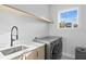 Clean laundry room with modern washer and dryer, bright light, and a neutral-toned design at 468 44Th N Ave, St Petersburg, FL 33703
