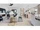 Open-concept living space with modern fireplace, light wood floors, and seamless flow to the kitchen at 468 44Th N Ave, St Petersburg, FL 33703