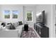 Stylish living room featuring a gray sectional sofa, plush rug, and modern entertainment center at 468 44Th N Ave, St Petersburg, FL 33703