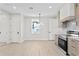 Bright open-concept living space features white walls, light floors, and a modern chandelier at 468 44Th N Ave, St Petersburg, FL 33703