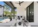 Relaxing patio with seating area, modern white table, ceiling fan, and view of the pool area at 468 44Th N Ave, St Petersburg, FL 33703