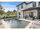 Swimming pool and spa with patio lounge furniture, landscaping, and adjacent covered outdoor seating area at 468 44Th N Ave, St Petersburg, FL 33703