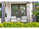 A cozy front porch features white cushioned seating and lush green landscaping at 468 44Th N Ave, St Petersburg, FL 33703