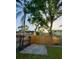 Cozy backyard with a wooden fence and a well-maintained grassy area with an area that can be used as parking or storage at 5110 Corvette Dr, Tampa, FL 33624