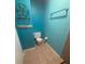 Small bathroom featuring toilet, tiled floor and storage rack and bar at 5110 Corvette Dr, Tampa, FL 33624