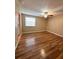 A spacious bedroom featuring wood floors and a bright window at 5110 Corvette Dr, Tampa, FL 33624