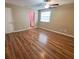 Bright bedroom with sleek wood laminate flooring, a ceiling fan and a window allowing for natural light to enter the space at 5110 Corvette Dr, Tampa, FL 33624
