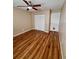 A cozy bedroom with wood floors, closet, and neutral walls at 5110 Corvette Dr, Tampa, FL 33624