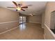 Bright living room with neutral paint, tile flooring, ceiling fan and views of the porch through sliding glass doors at 5110 Corvette Dr, Tampa, FL 33624