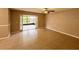Inviting living room features tile floors, neutral paint, and natural light from the sliding glass doors leading to outdoor porch at 5110 Corvette Dr, Tampa, FL 33624