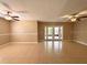 Spacious living room featuring tile floors, neutral walls and a view to the outdoor space via the double doors at 5110 Corvette Dr, Tampa, FL 33624