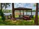 Covered pavilion with picnic tables and a grill by a lake for outdoor gatherings at 5110 Corvette Dr, Tampa, FL 33624