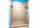 Tiled stand up shower with neutral tone, two shelves and new shower head and faucet at 5110 Corvette Dr, Tampa, FL 33624