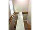 A staircase with wood treads, a white banister, and a window letting in light at 5110 Corvette Dr, Tampa, FL 33624