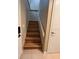 A clean staircase with wood-look steps and white railing at 5110 Corvette Dr, Tampa, FL 33624