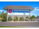 Springwood II community entrance sign with flower detail, set amid lush landscaping and greenery at 5390 Magnolia N Trl, Pinellas Park, FL 33782