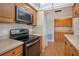 Well-lit kitchen featuring modern appliances and light wood cabinetry at 5390 Magnolia N Trl, Pinellas Park, FL 33782