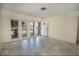 Bright living room with tile flooring, large windows offering natural light and a decorative front door at 5390 Magnolia N Trl, Pinellas Park, FL 33782