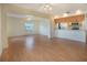 Bright and airy living space with an open kitchen and neutral laminate flooring at 5390 Magnolia N Trl, Pinellas Park, FL 33782