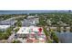 Aerial view of a building with a rooftop terrace close to a pond, a parking garage, and the city at 610 S Rome Ave # 602, Tampa, FL 33606