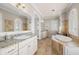 Spacious bathroom with dual vanities, garden tub, travertine tile, and lots of light at 610 S Rome Ave # 602, Tampa, FL 33606