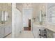 Dual sink bathroom with unique wallpaper, tile floors and updated fixtures at 610 S Rome Ave # 602, Tampa, FL 33606